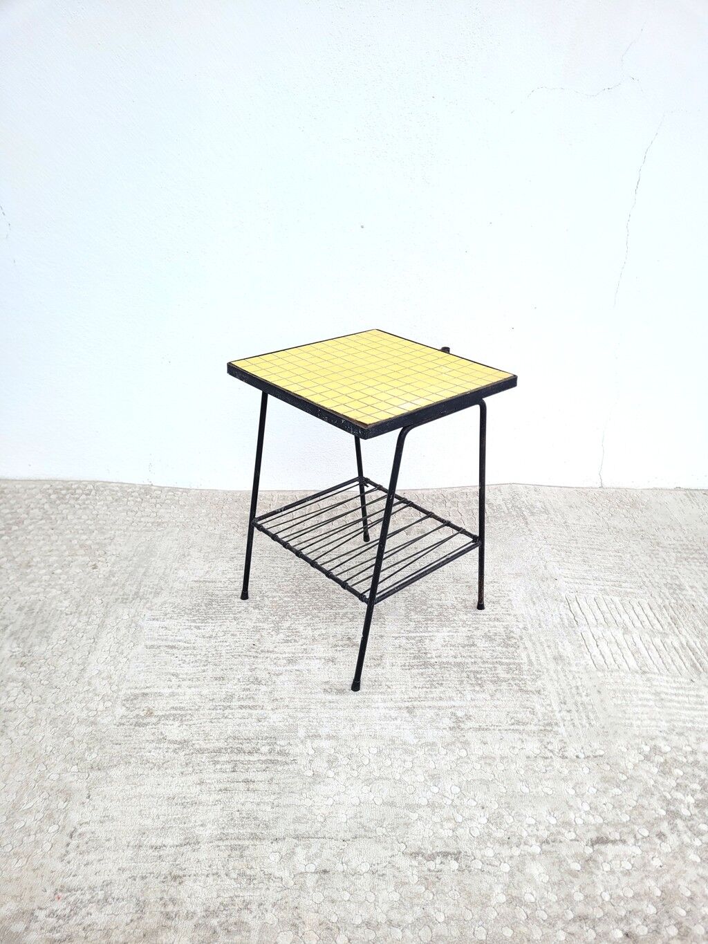 Small vintage yellow side table with magazine rack.