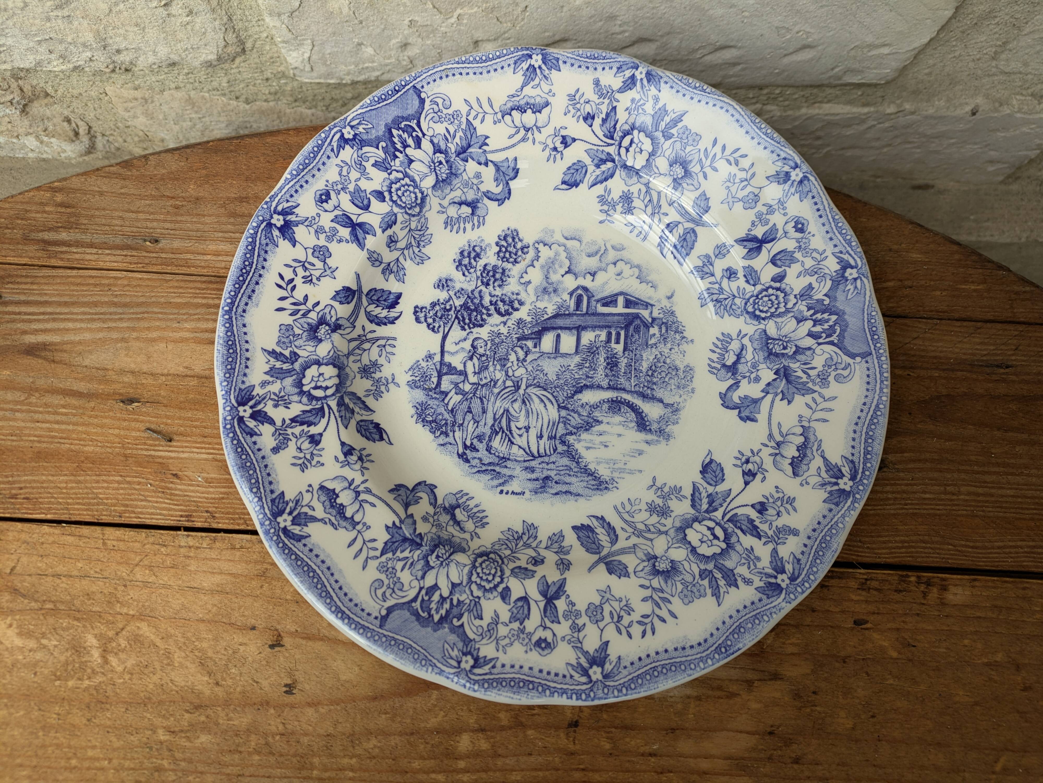 Old deep plate with blue floral pattern and gallant scene
