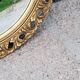 Round neoclassical style mirror in wood and gilded stucco from the 1950s