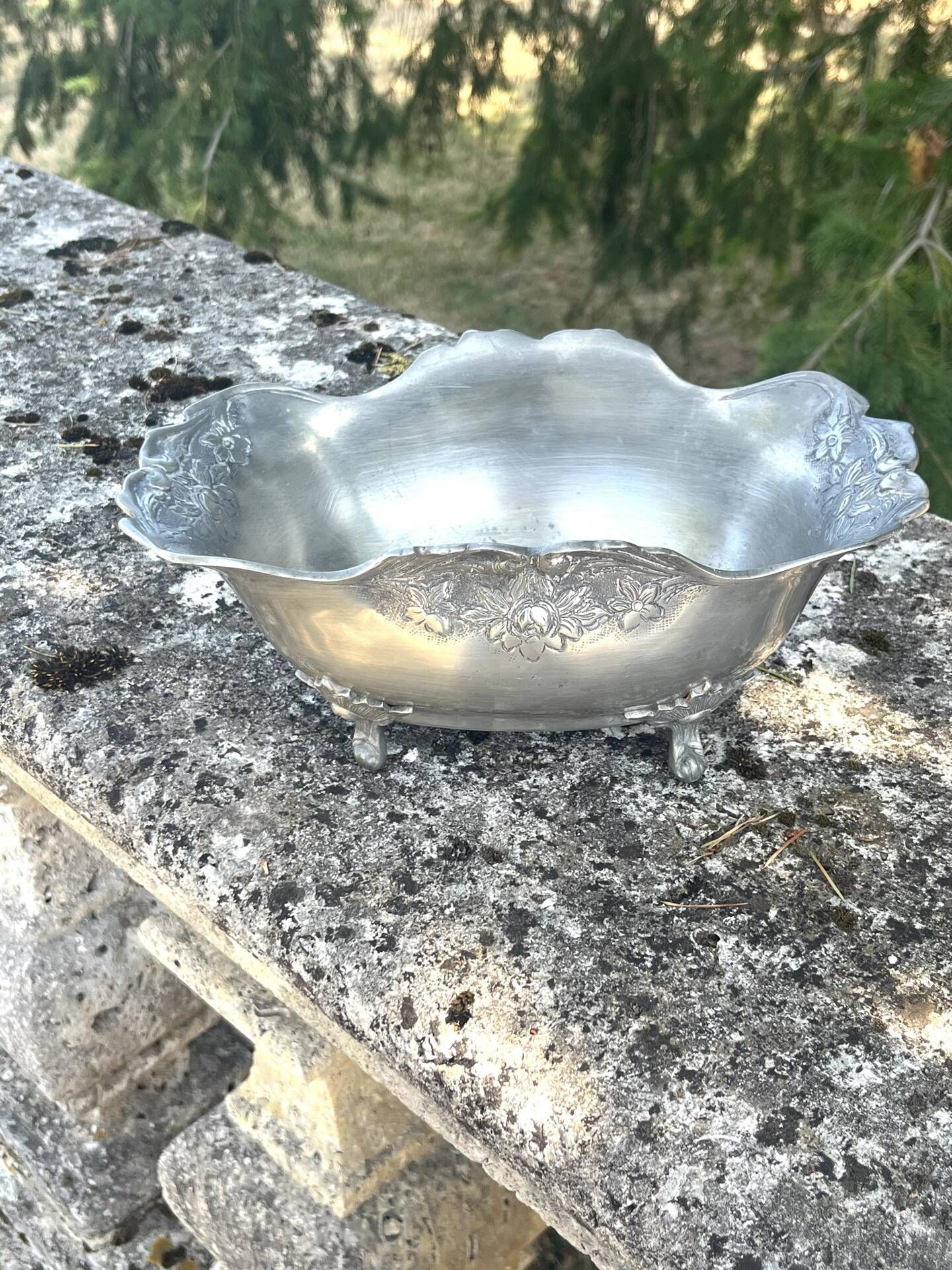 Footed pewter champagne cooler on claw feet with floral relief
