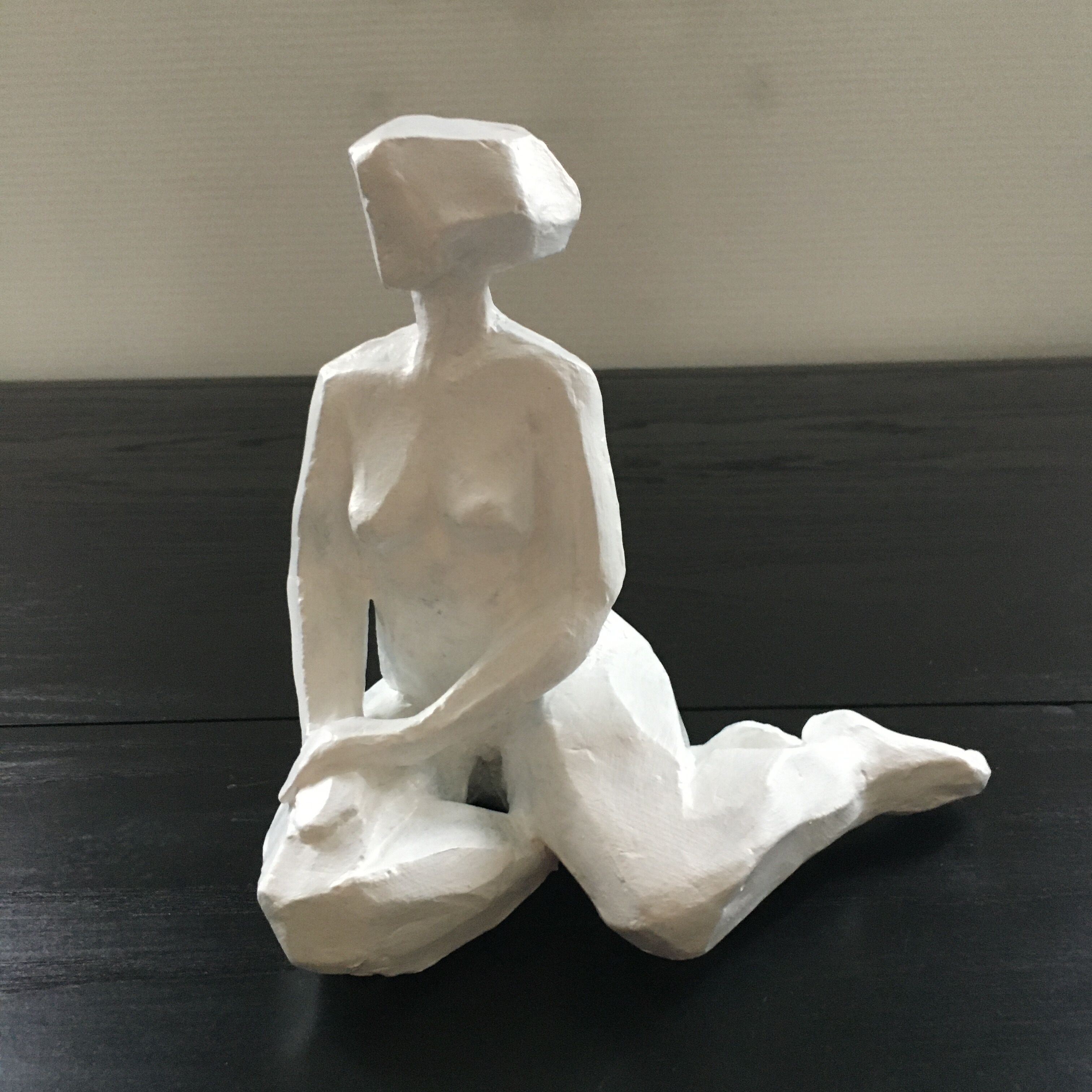 Statuette woman seated in plaster