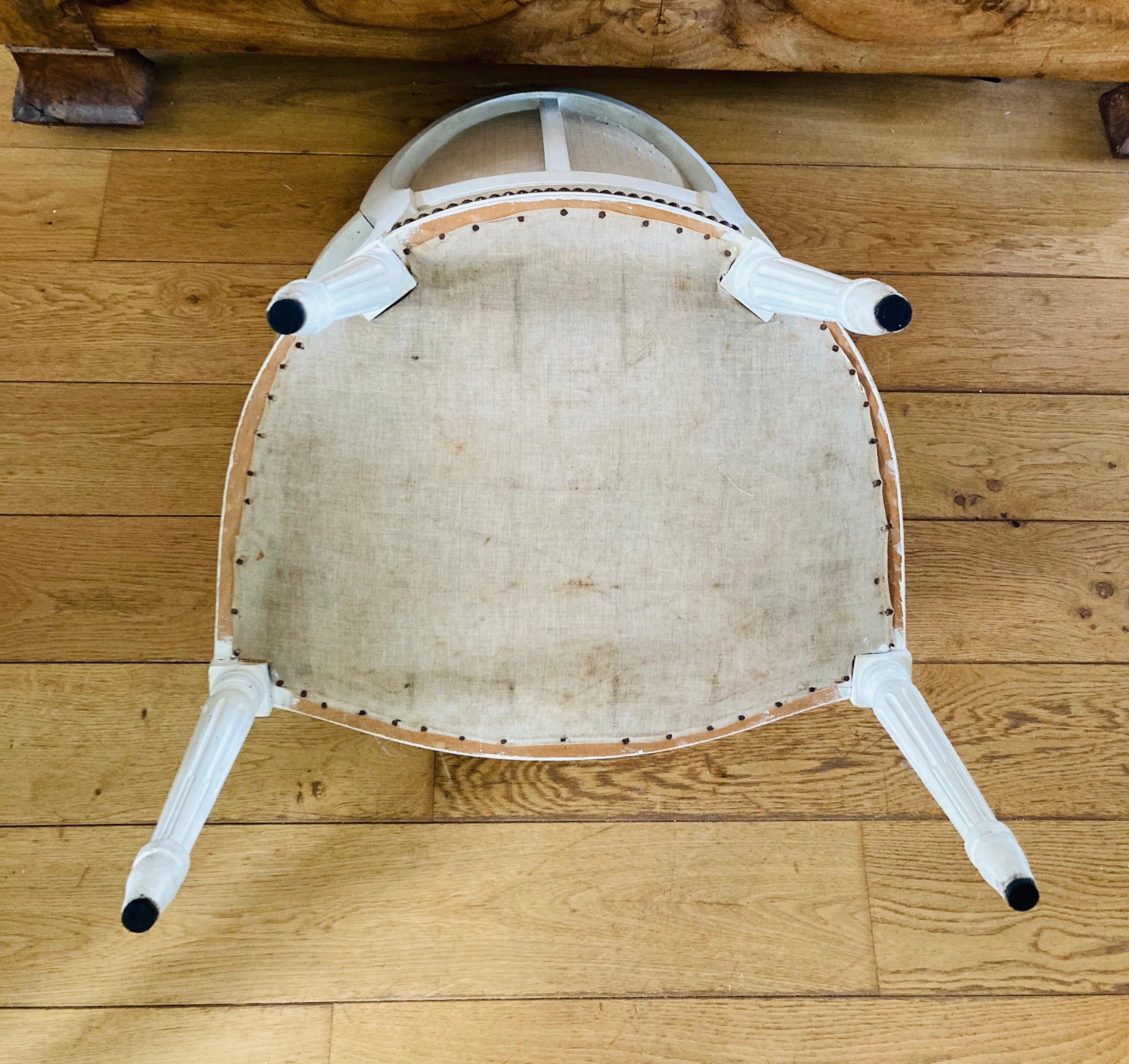 Upholstered armchair with cross-stitch in the Louis XVI style, 19th century.
