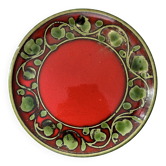 Red plate with green decoration.