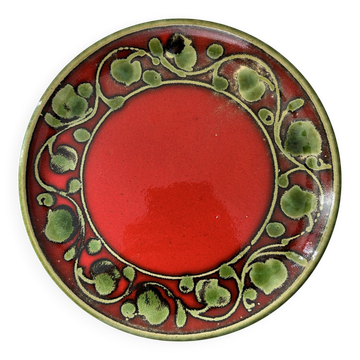 Red plate with green decoration.