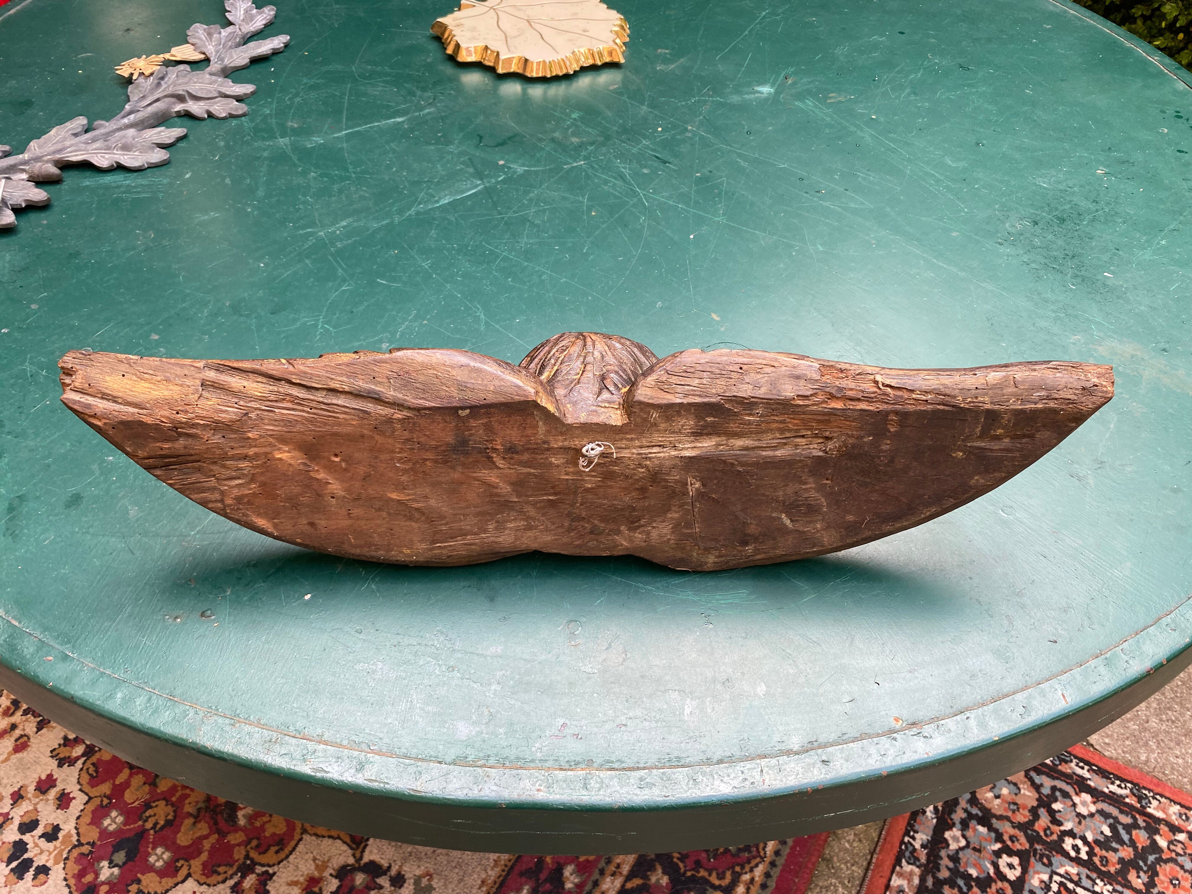 Carved wooden angel head