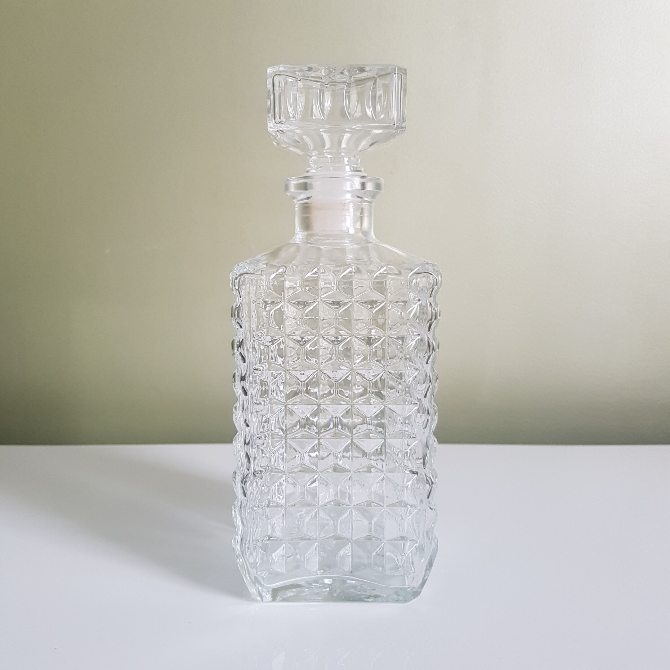 A square glass whiskey decanter