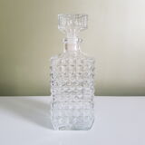 A square glass whiskey decanter