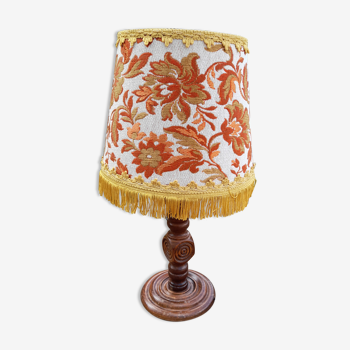 Table lamp, wooden foot way dice and lampshade upholstered embroidered flowers, golden fringes, vintage