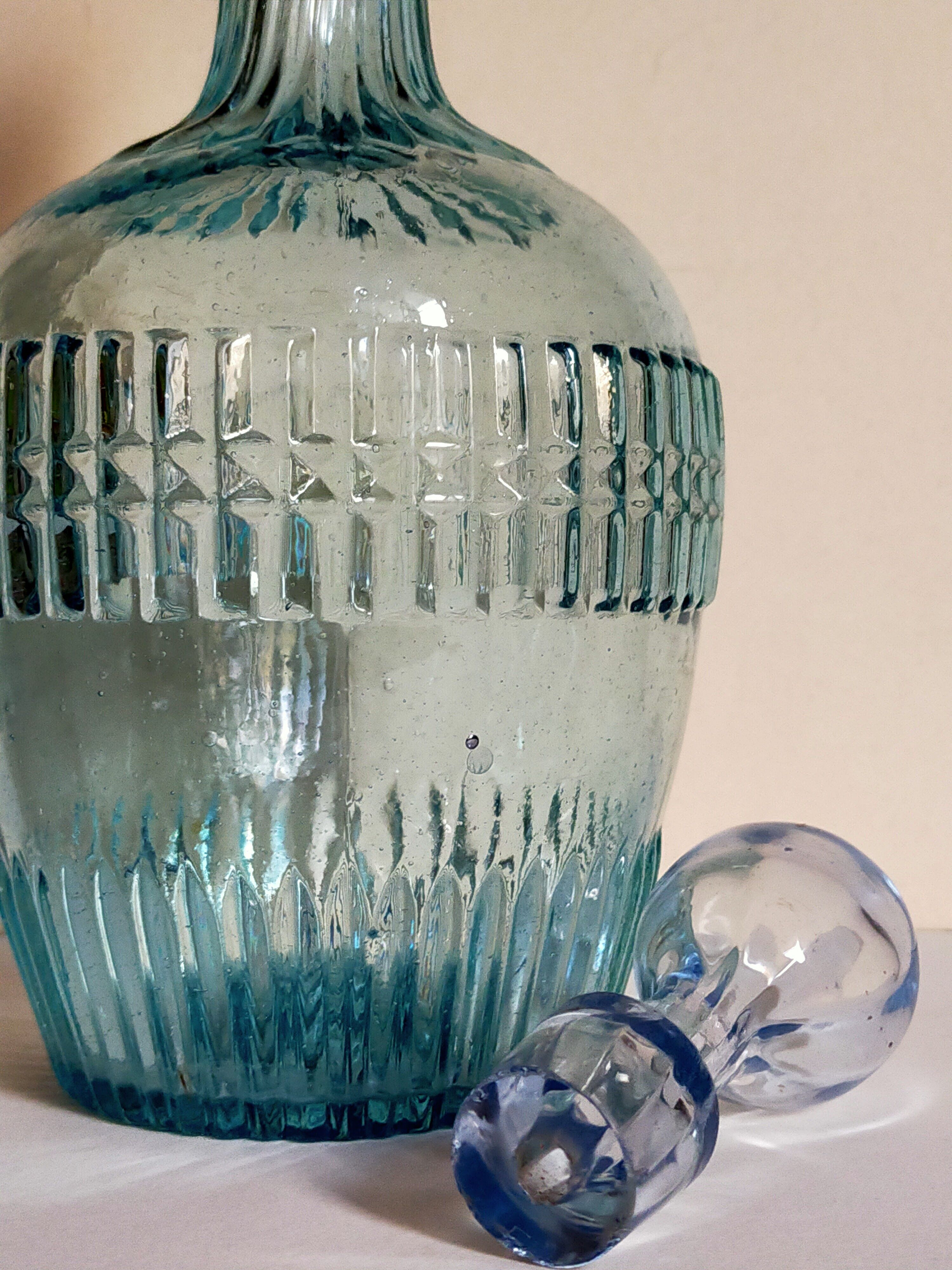 Blue glass carafe with vintage pegs