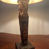 Old lamp with carved wooden base representing a wise man