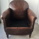 Club armchair in studded leather - early twentieth century