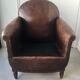 Club armchair in studded leather - early twentieth century