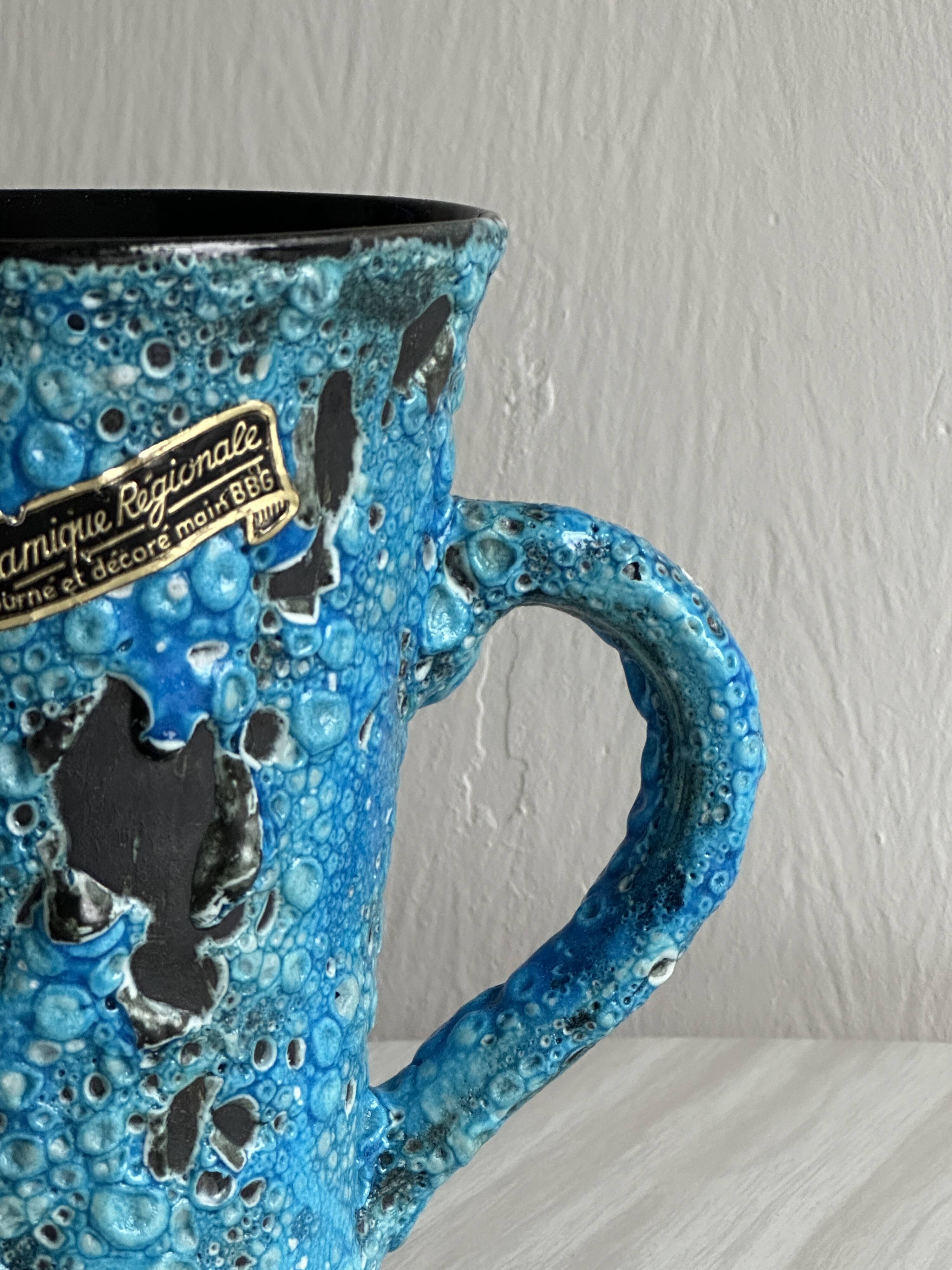 Blue glazed ceramic pitcher