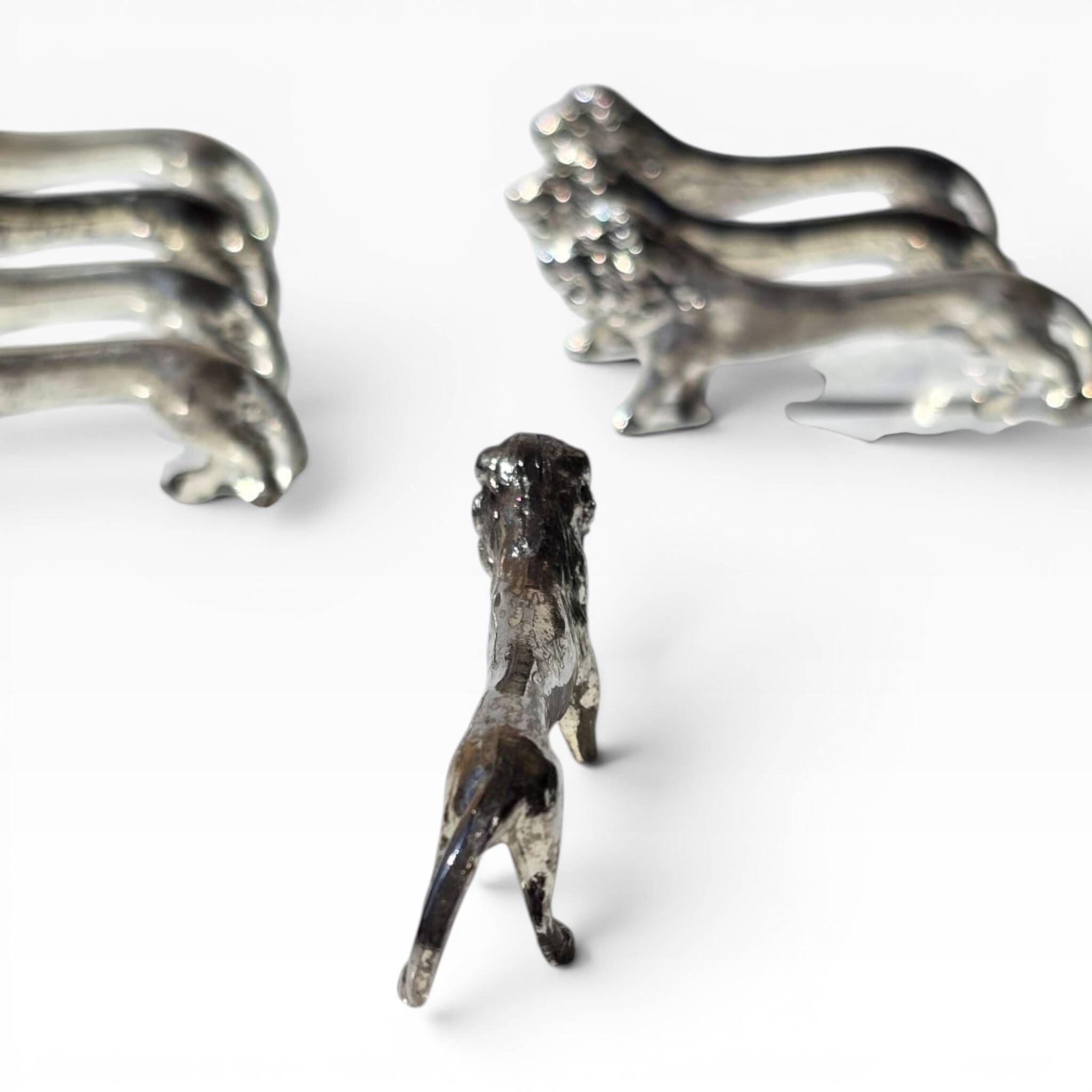 Series of antique knife rests in the shape of a lion, silver-plated metal.