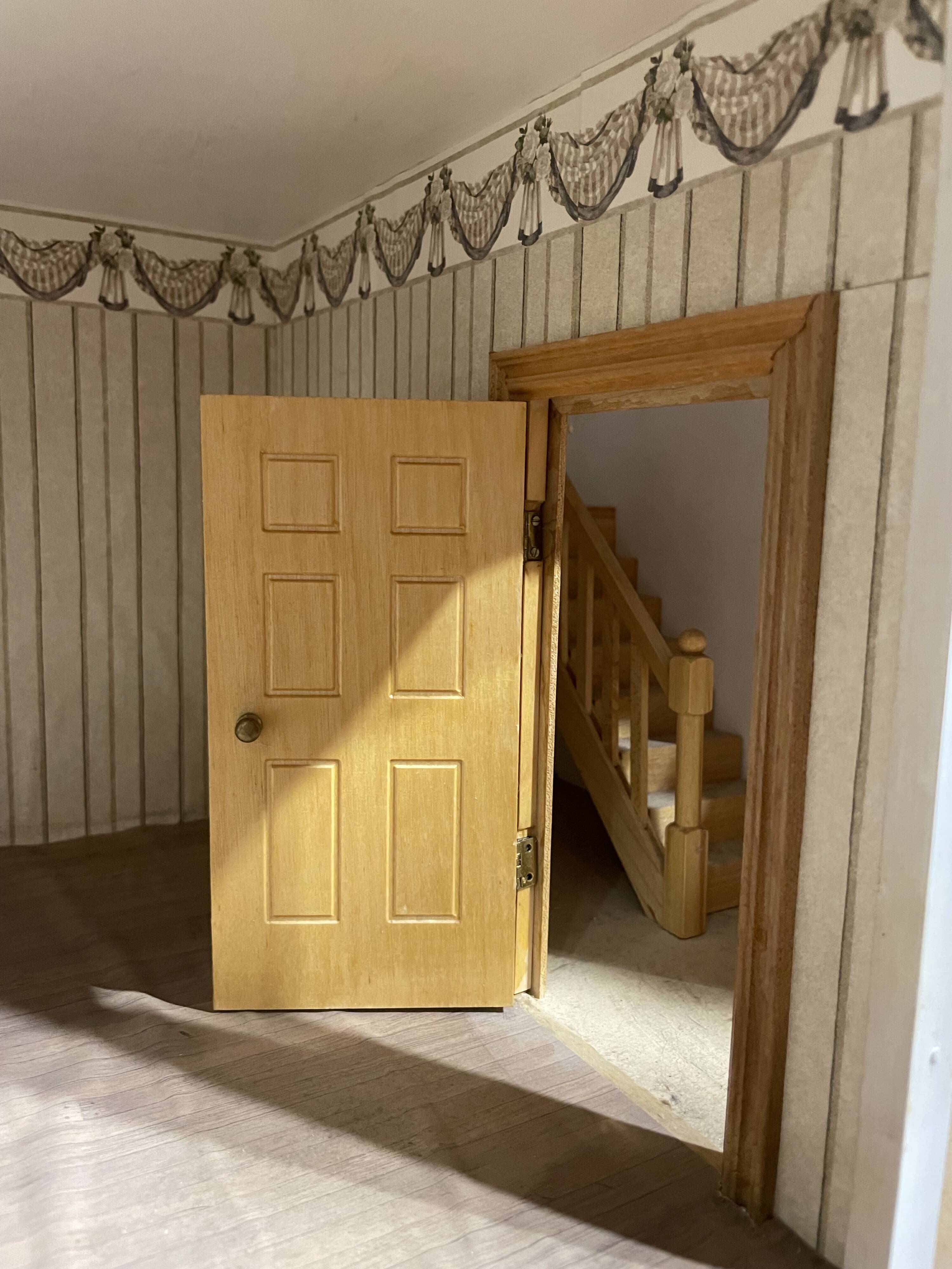 Large wooden dollhouse with miniature furniture