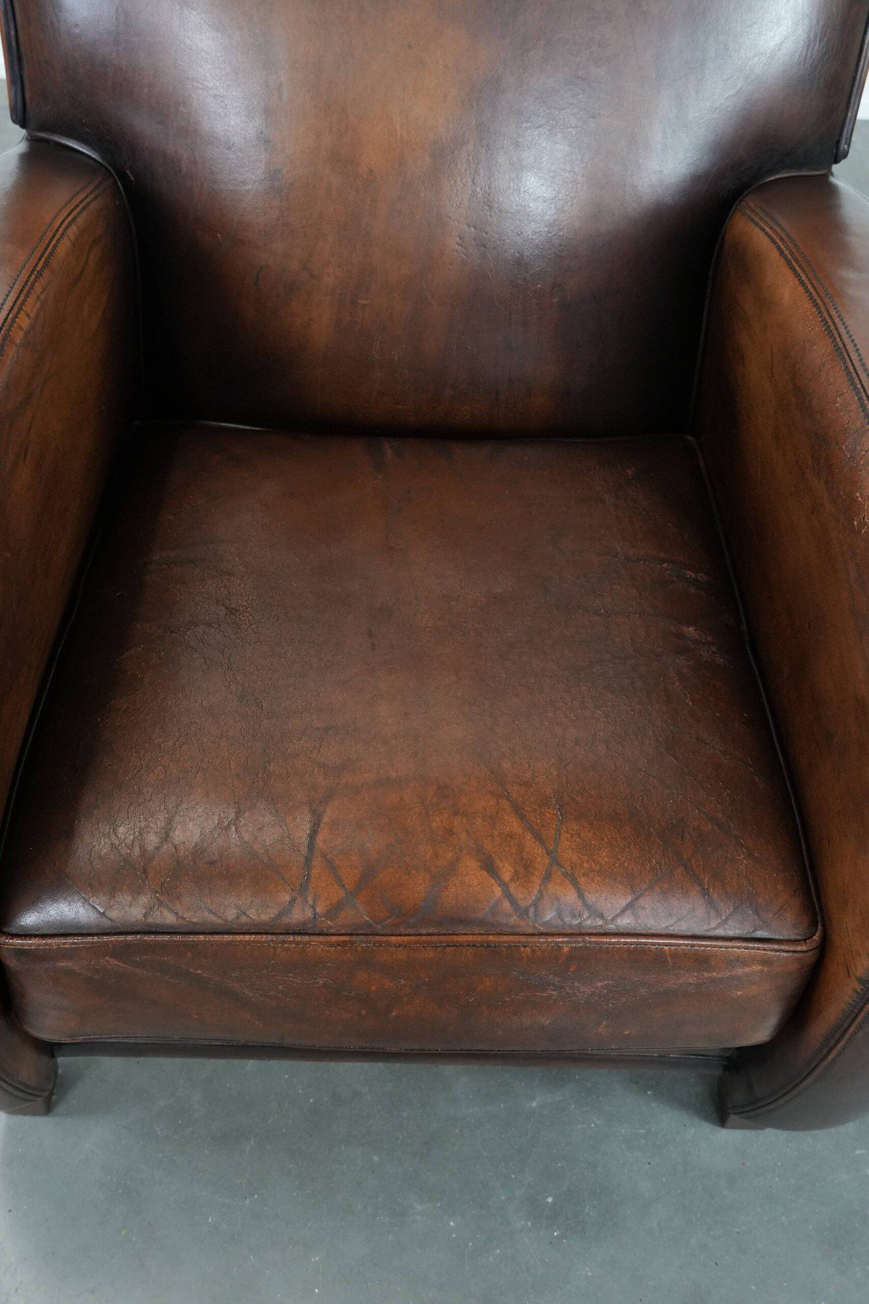 Beautifully shaped vintage sheepskin armchair with character