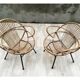 Pair of rattan shell chairs with metallic feet