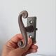 Old window handle with a forged iron cremon.
