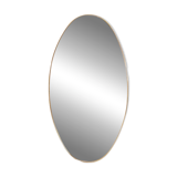Oval shaped mirror set with a gilded brass rod. 1970s.