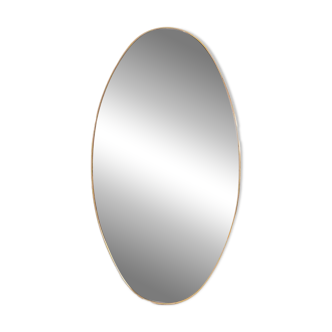 Oval shaped mirror set with a gilded brass rod. 1970s.