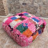 Berber floor pouf: Handwoven Moroccan wool cushion.