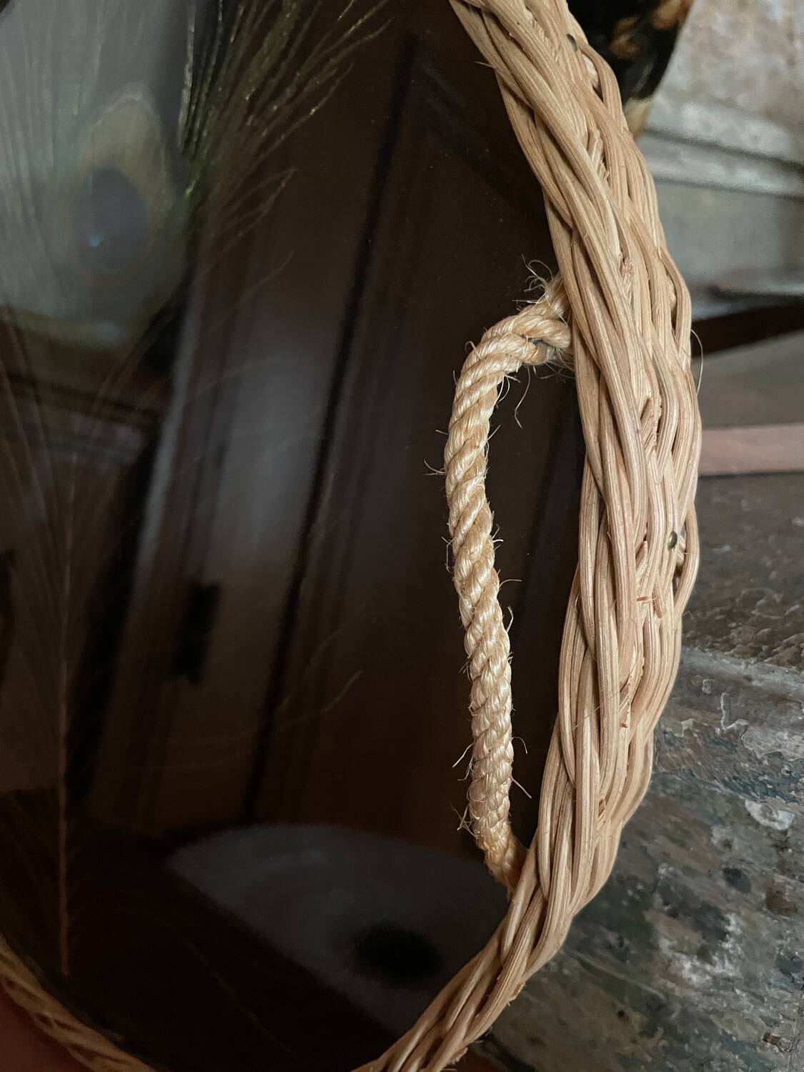 Vintage rattan tray with peacock feather