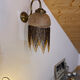 Wall lamp with marbled glass shade and beaded fringe in Art Nouveau style.