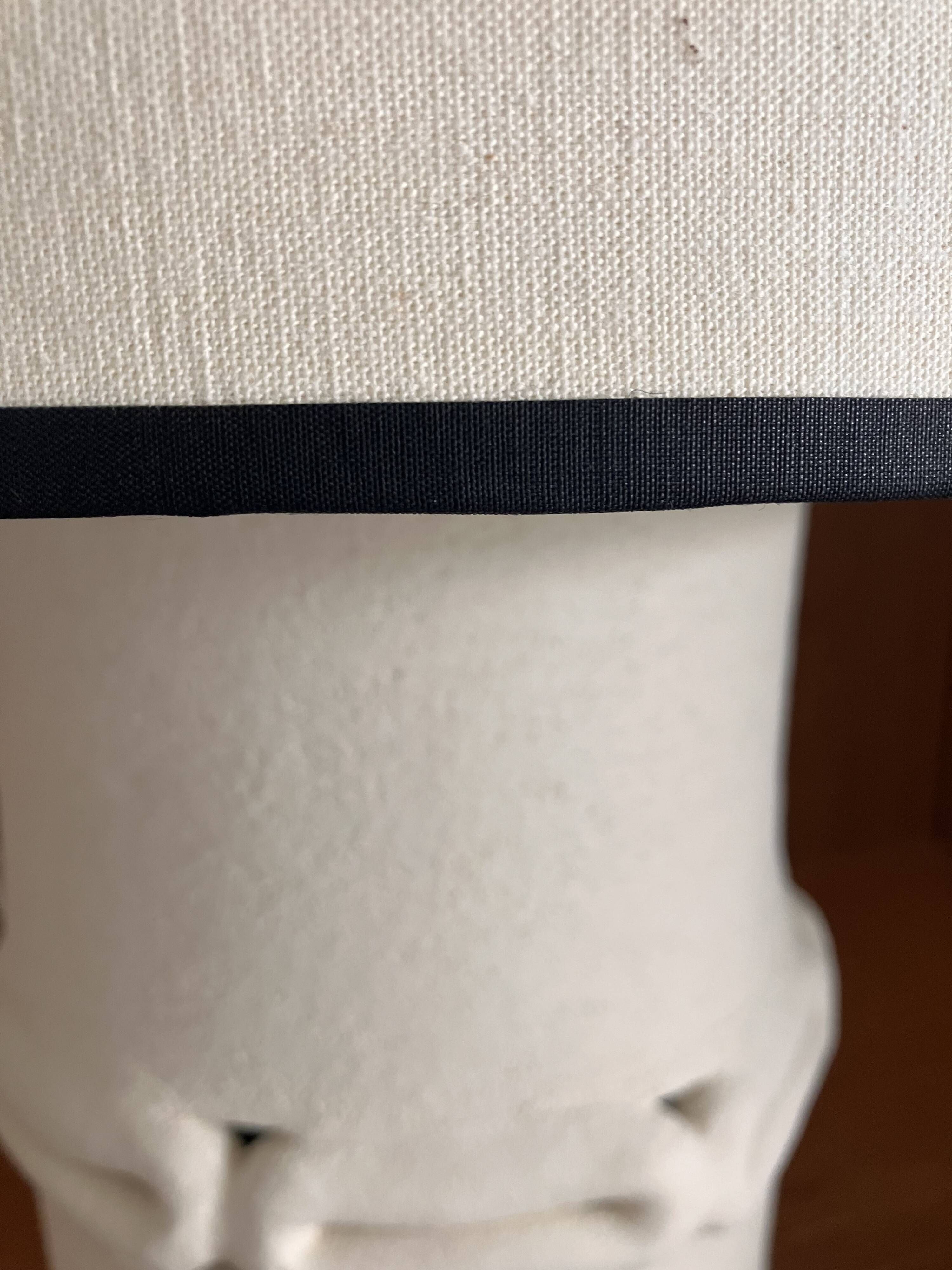 Table lamp in ceramic with a handmade couture-style lampshade from France.