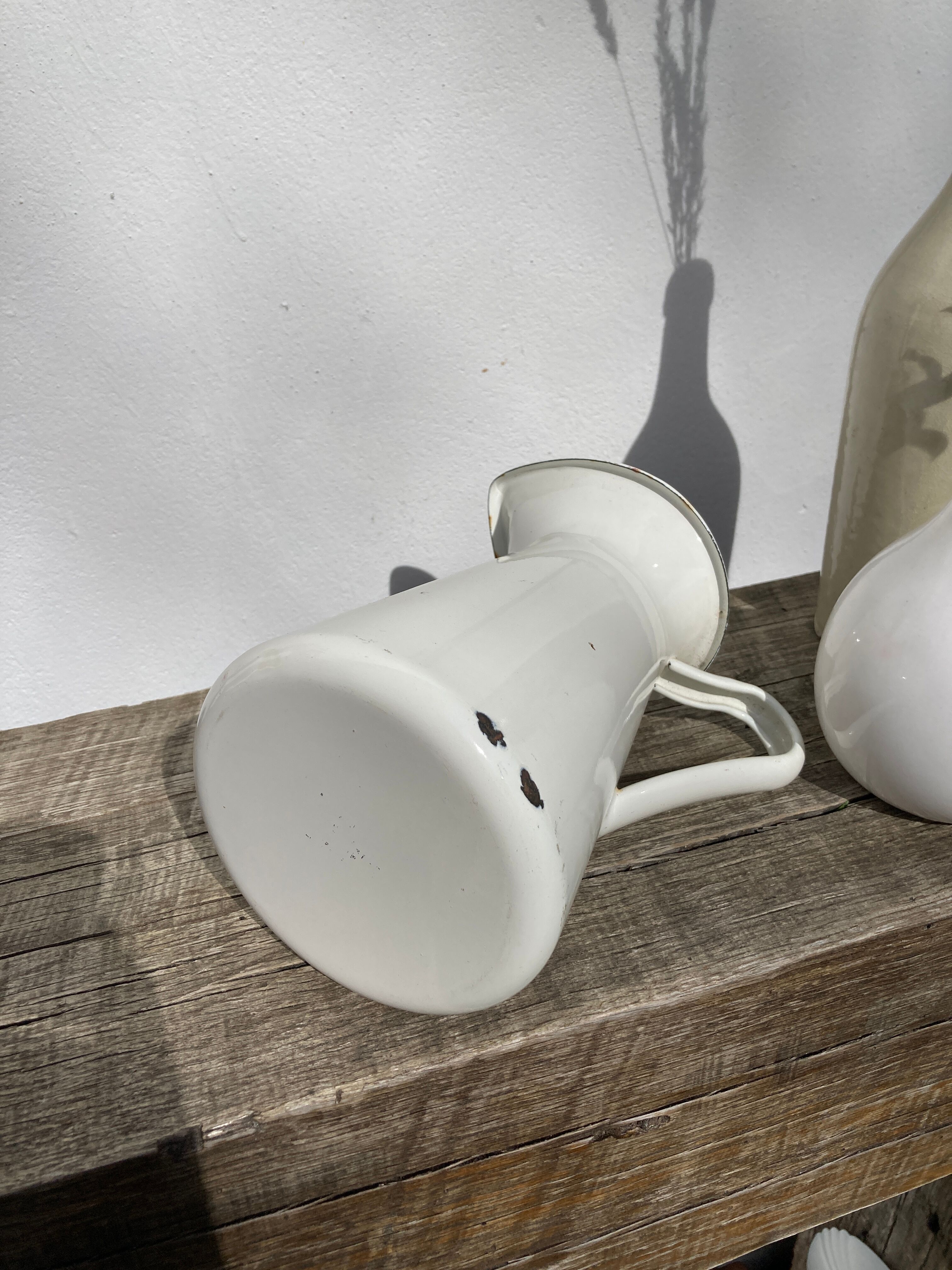 Old white enamelled metal pitcher