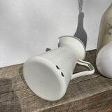 Old white enamelled metal pitcher