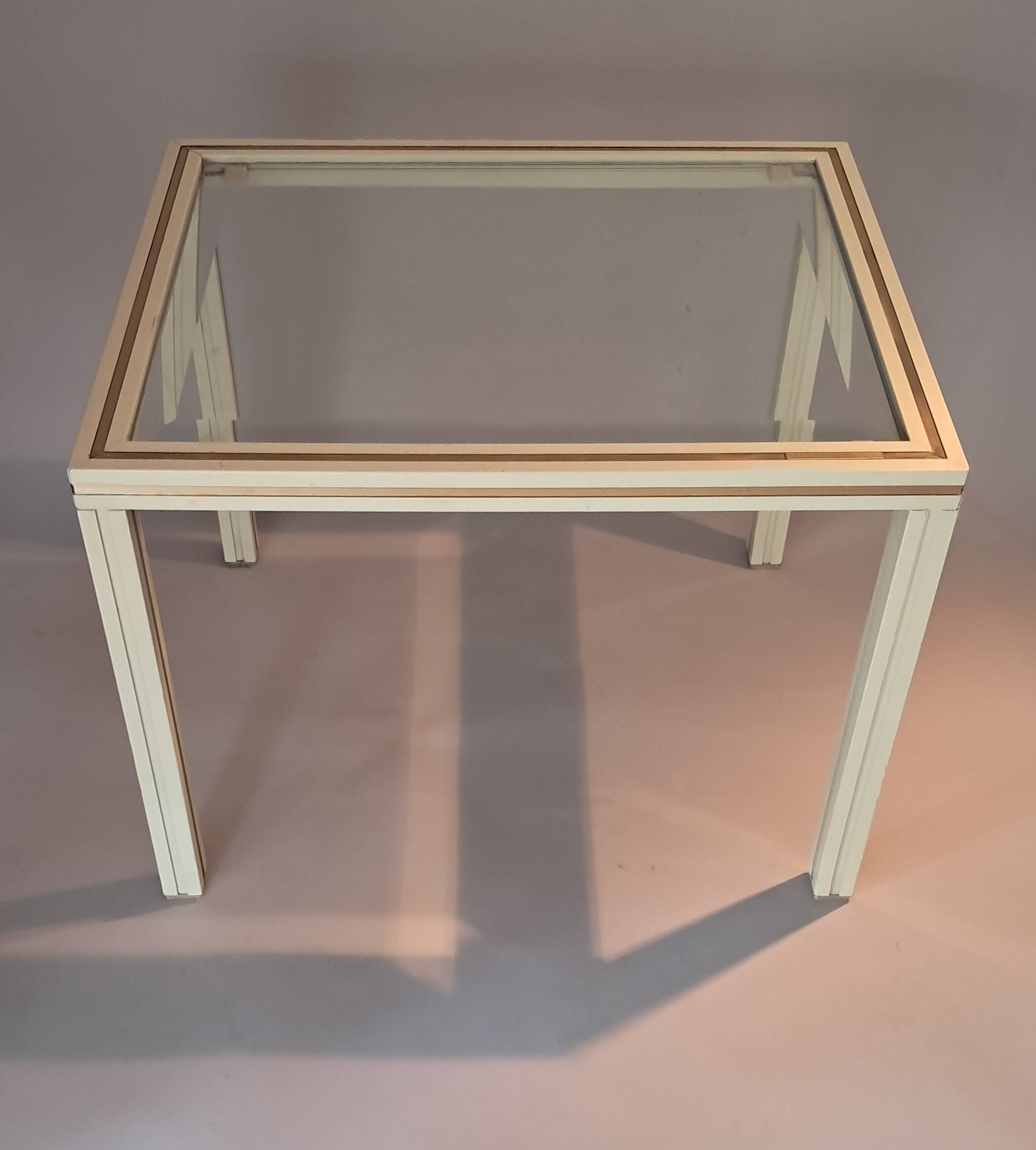 White lacquered side table by Pierre Vandel with gold brass.
