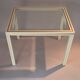 White lacquered side table by Pierre Vandel with gold brass.
