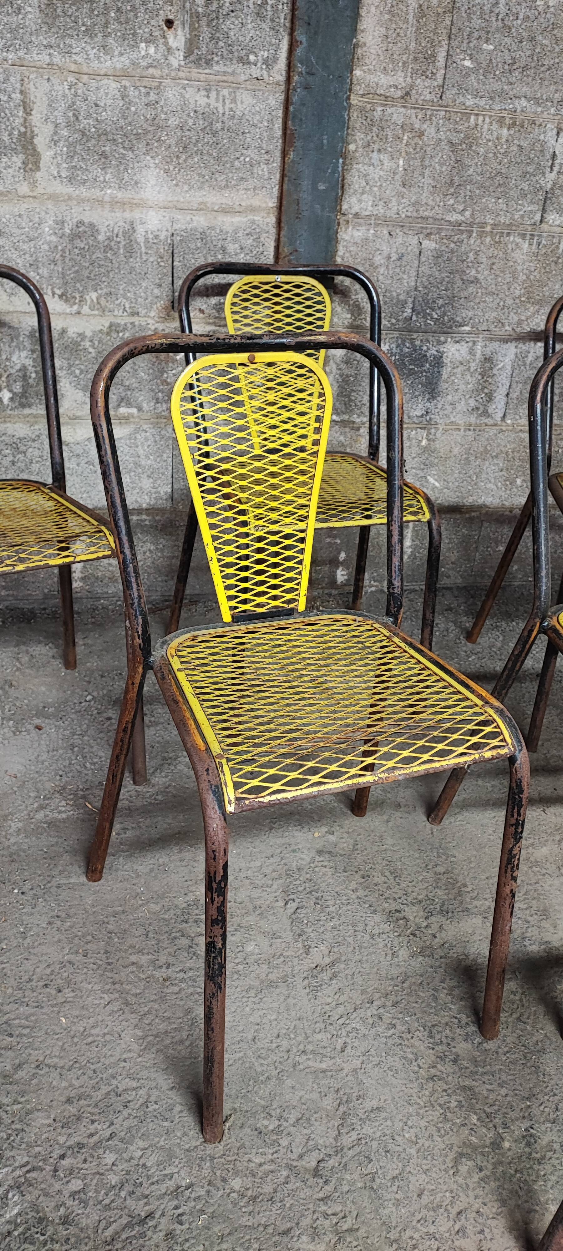 Six chaises en métal perforé seducta René Malaval