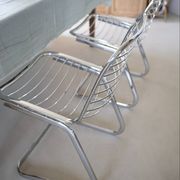Lot of 2 chrome metal chairs by Gastone Rinaldi.