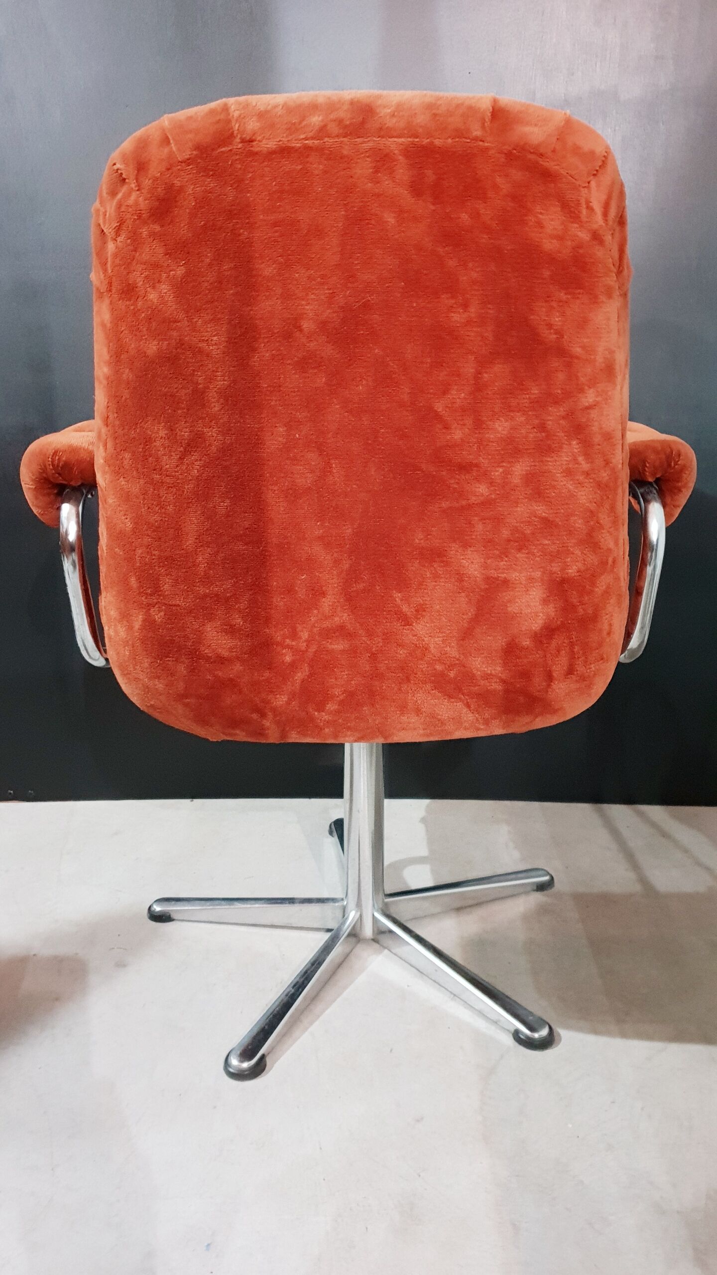 Orange velvet swivel armchair
