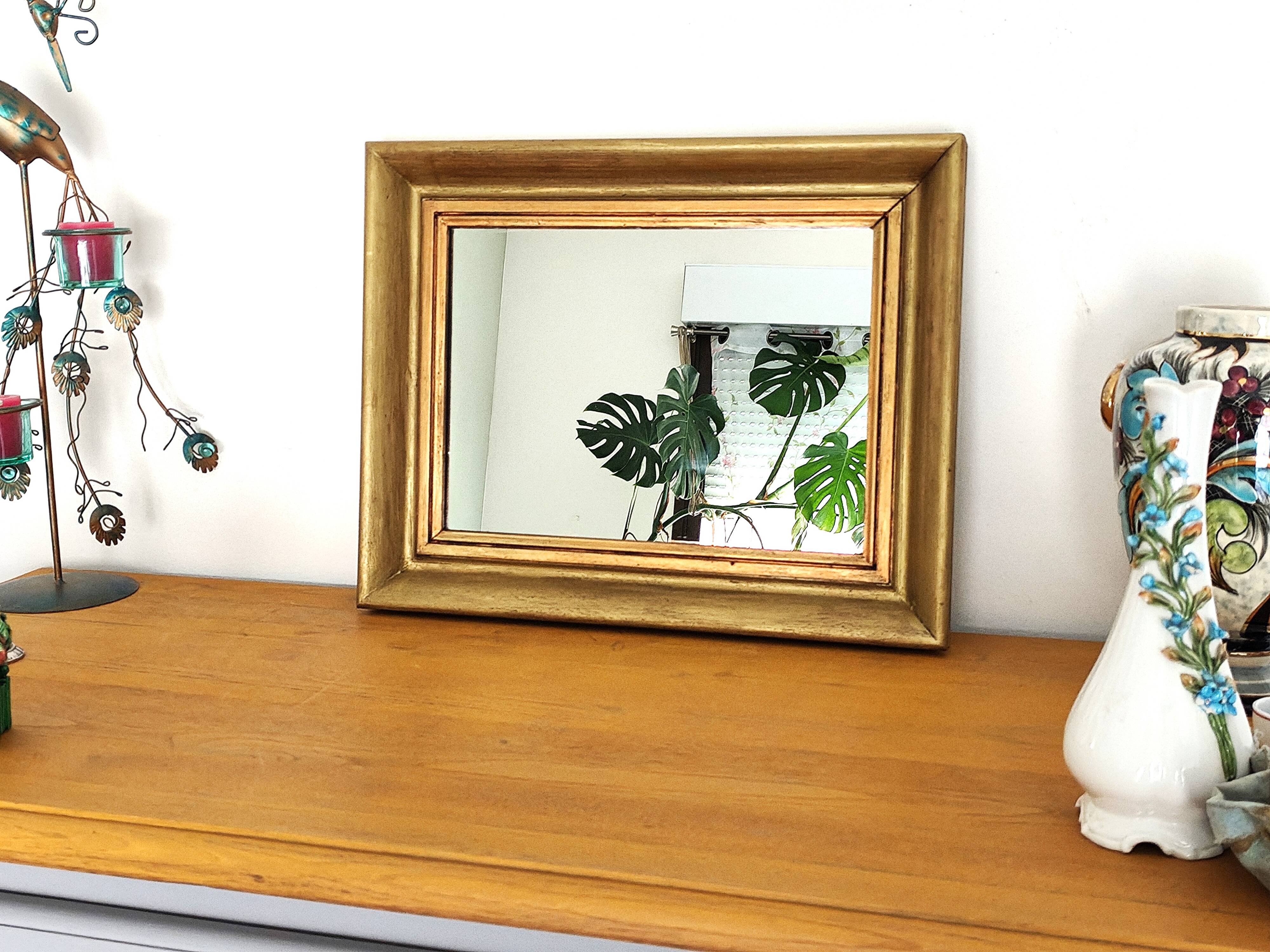 Antique mirror in gilded and copper wood