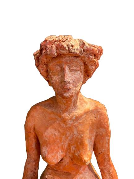 Painted plaster sculpture of a nude woman on a bench