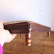 Small antique wooden and fabric footrest.