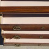 Chest of drawers with decorated handles in the Louis XVI style.