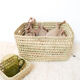Storage basket in braided palm leaves