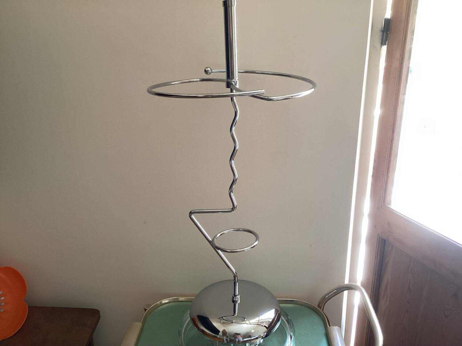 Designer umbrella stand in chrome metal and wood.