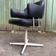 Pair of vintage armchairs in black skai with metal legs.
