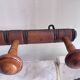 Wall-mounted coat rack with 8 turned wooden hooks in faux bamboo style.