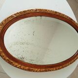 Antique oval mirror with beveled glass in wood and stucco, 19th century