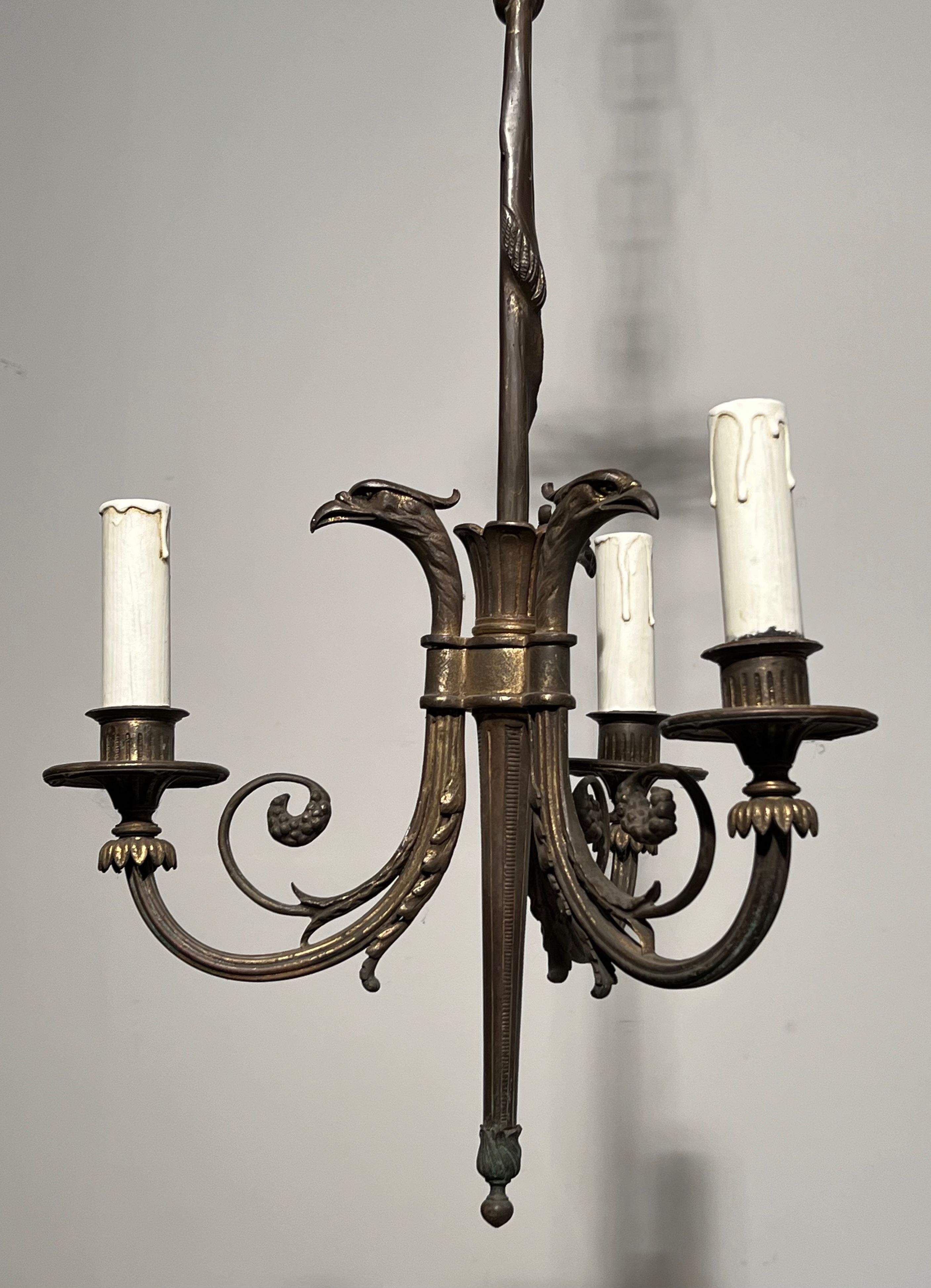 Empire-style bronze chandelier with 3 arms of light topped with eagle heads. French work. Circa 1900.