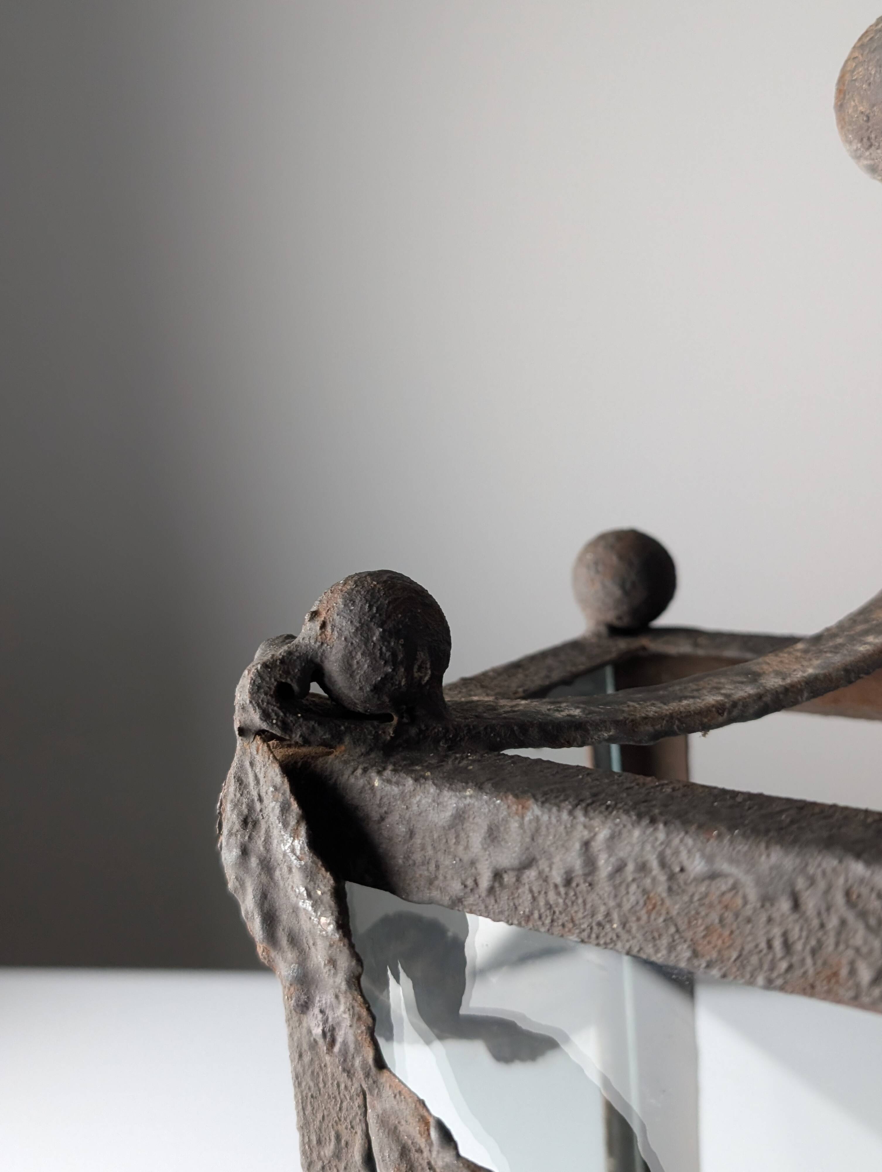 Wrought iron lantern with glass panels, leaf motifs