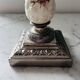 Silver-plated metal and porcelain candlestick
