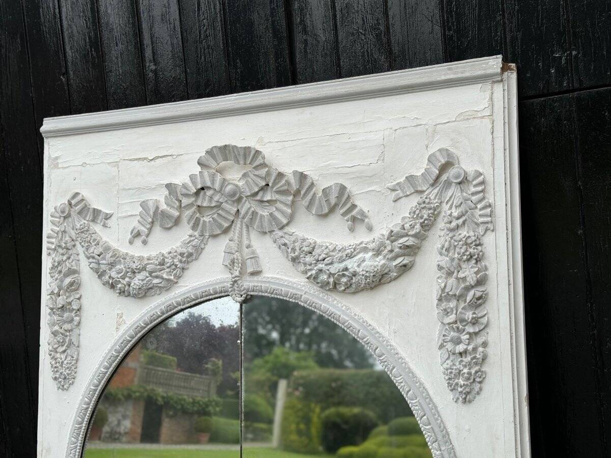 Louis XVI style fireplace mirror, carved wood trumeau with white and grey highlights, 18th century