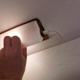 A pair of teak wood wall lamps with plastic shade.