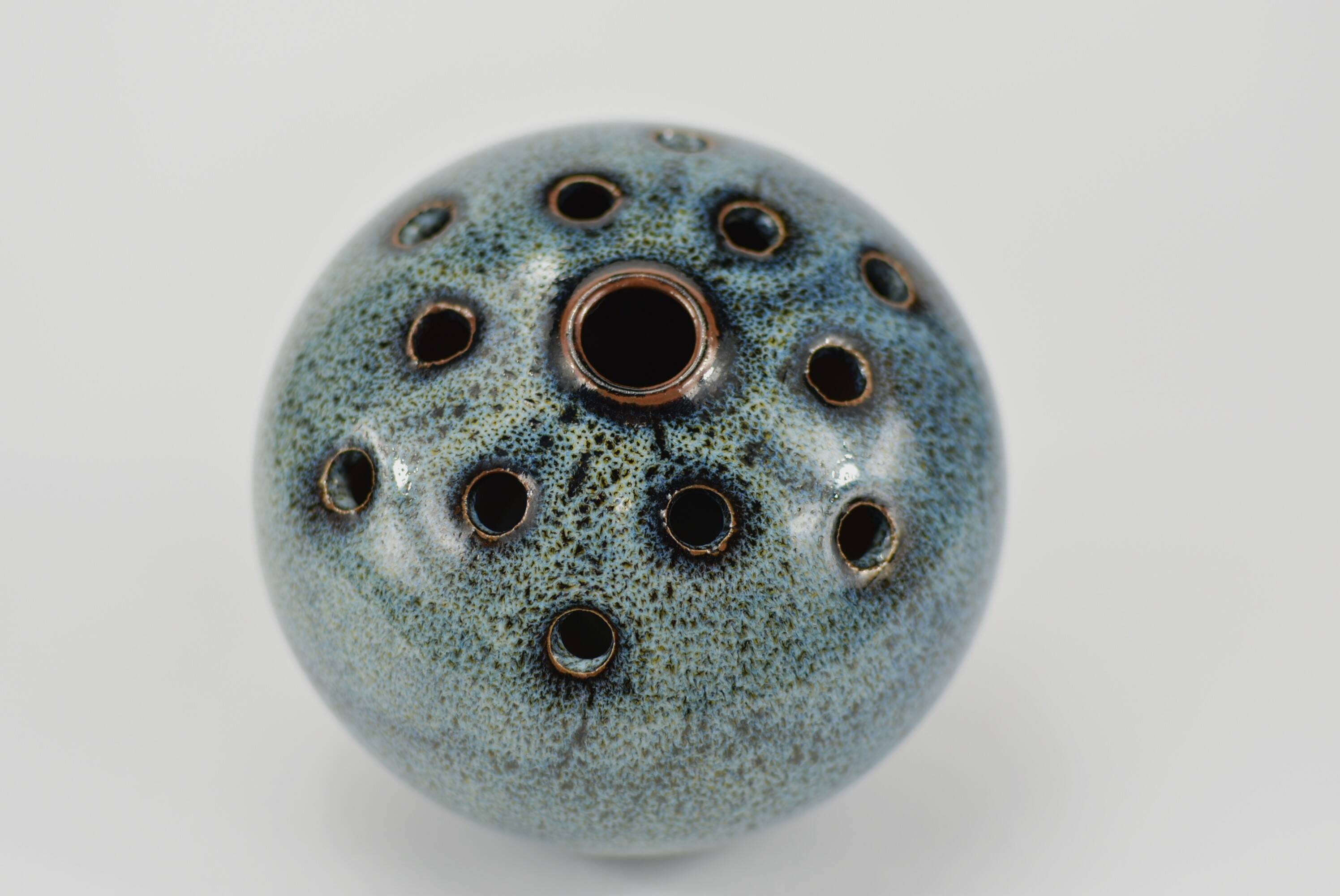 Vase with blue flowers.